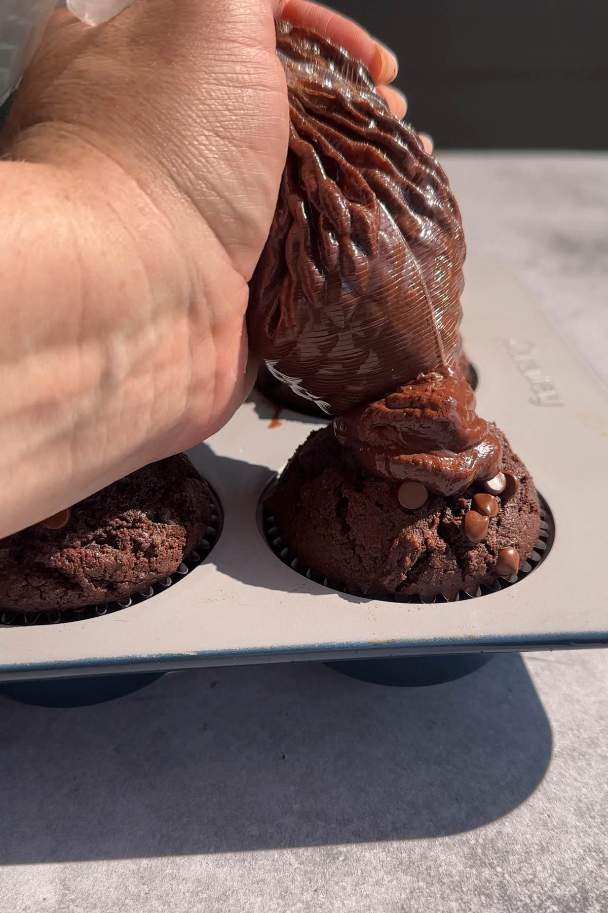 Filling ganache in a double chocolate muffin